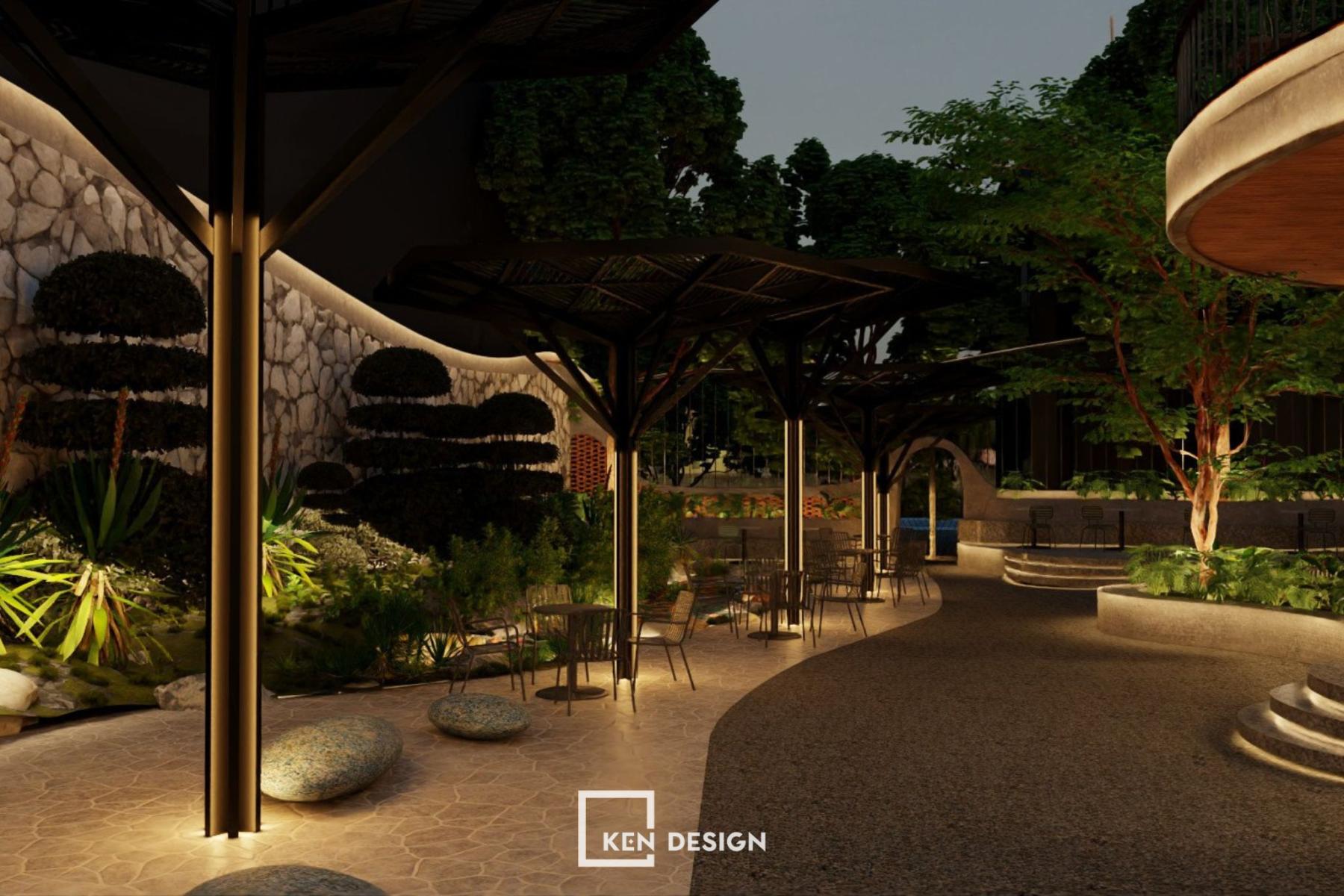 sân vườn ban đêm có cột đèn LED và lối đi cong hắt sáng trong thiết kế quán cafe phong cách hiện đại