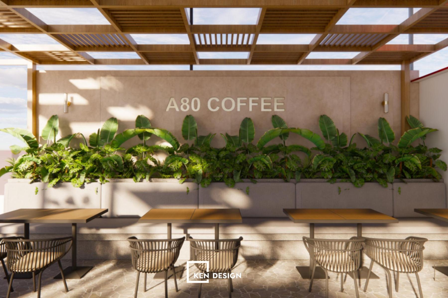 dải chậu cây lá lớn dọc tường làm nền bảng hiệu trong thiết kế quán cafe phong cách trẻ