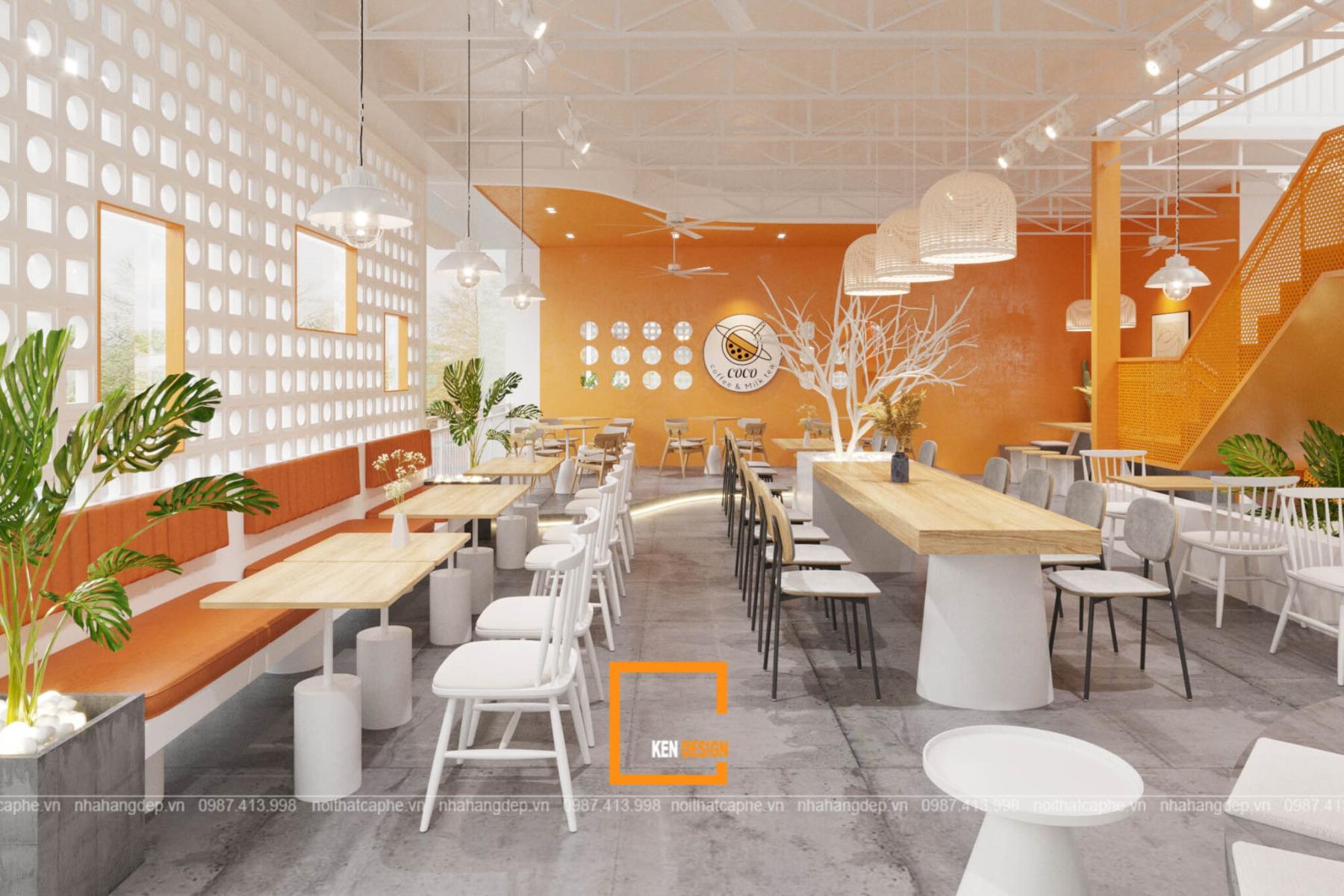 một mảng tường cam giữa nền trắng gỗ sáng, cách phối màu có chủ đích trong quán cafe phong cách hiện đại